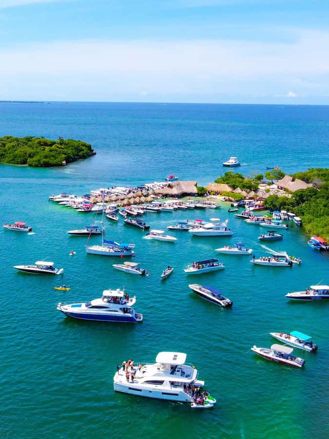 Cartagena: 4 Island Day Trip by Boat and Caribbean Lunch - Cholón: social water, floating tables, and crowds