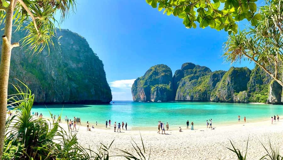 Longtail boats moored off a limestone island in the Andaman Sea