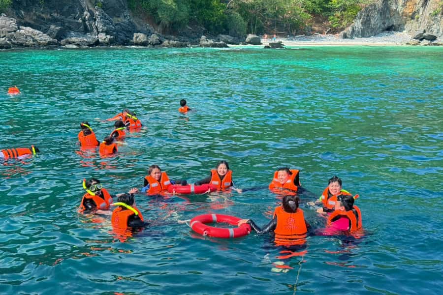 Phuket: Coral Island Day Trip and Sunset Dinner by Catamaran - Dinner, fruit, and the Promthep Cape sunset