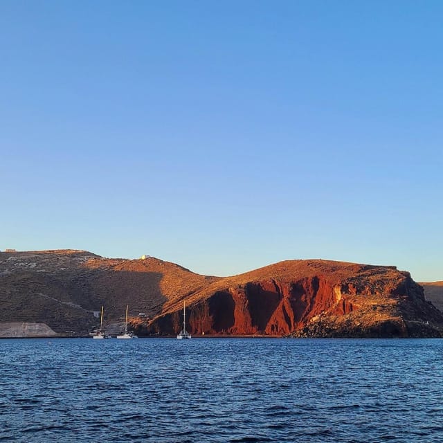 Santorini:Cruises with Catamaran around the Volcanic Island. - White Beach, the lighthouse, and Black Mountain