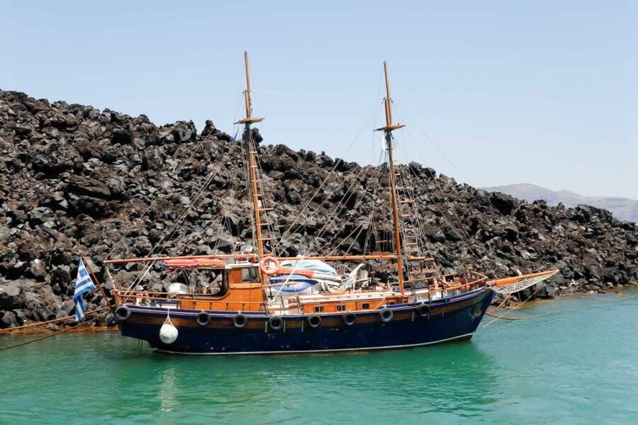 Santorini Island Bus Tour and Caldera Sunset Cruise - Boarding at Athinios and Seeing Santorini from the Water