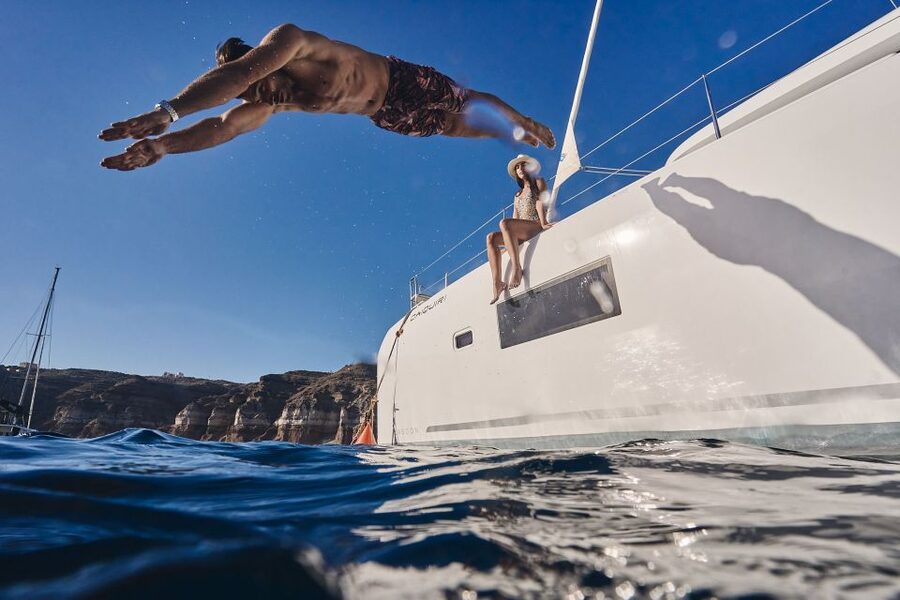 Santorini: Southern Island Luxury Catamaran Cruise with Meal - Red Beach and Santorini’s scarlet cliffs