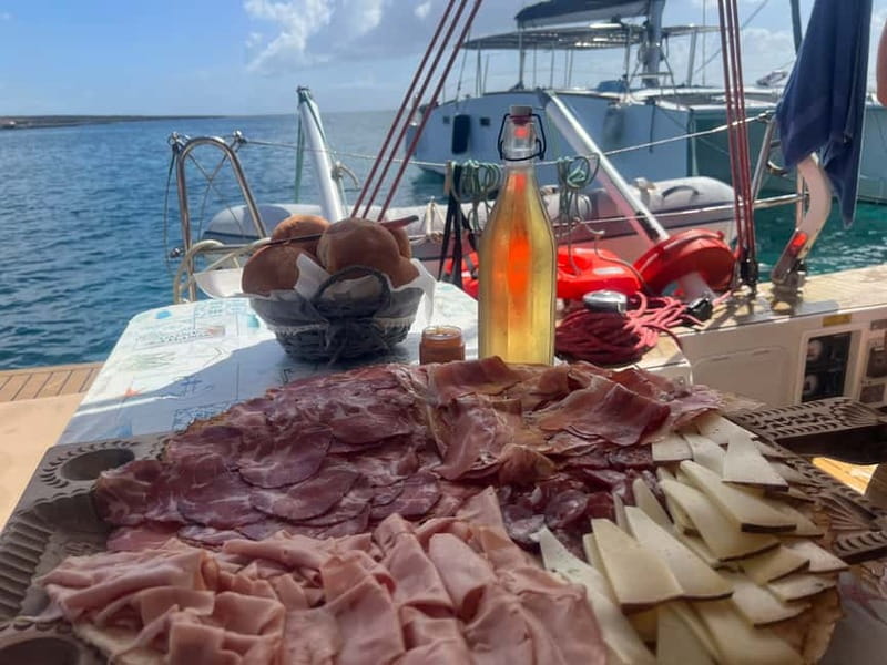 Stintino: full day tour catamaran Asinara Island - The first stop: Sardinian flavors on deck